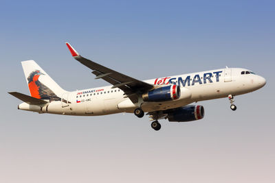 Airplane flying against clear blue sky