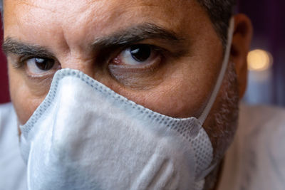 Closeup of man with a protective medical mask waits for the end of the emergency quarantine.