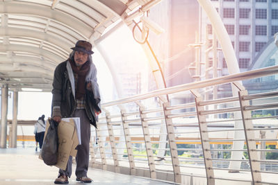 Man walking against built structure