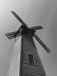 Low angle view of traditional windmill against sky