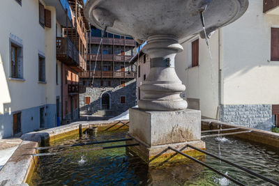 Fountain amidst buildings in city