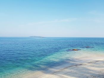 Scenic view of sea against clear blue sky