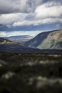 Scenic view of mountains against cloudy sky