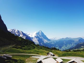 Scenic view of snowcapped mountains against clear blue sky