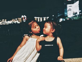 Portrait of friends standing at night