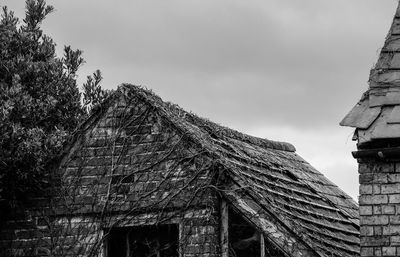 High section of abandoned house against sky