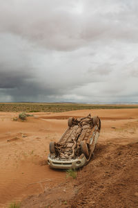 Subaru flipped on a slippery dirt mud road in the desert of utah