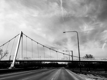 Road by bridge against sky