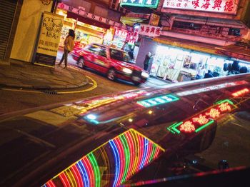 Blurred motion of man in illuminated city at night