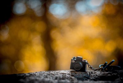 Close-up of miniature toy camera on wood