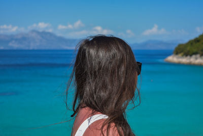 Close-up of woman standing against sea