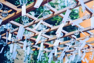 Low angle view of fortune papers hanging on wood