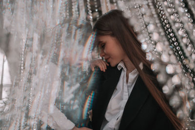 Side view of young woman standing outdoors