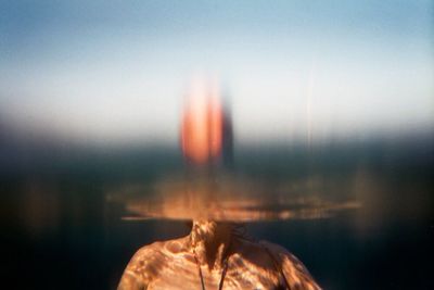 Close-up of man against sky during sunset