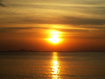 Scenic view of sea against orange sky