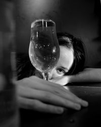 Portrait of woman drinking glass on table