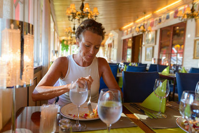 Woman eating food at restaurant