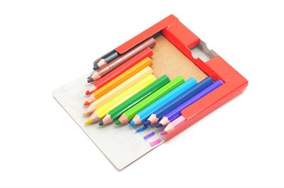 High angle view of multi colored pencils against white background