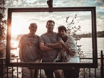 Portrait of family standing by frame