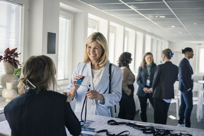 Woman picking up her pass before conference