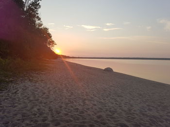 Scenic view of beach against sky during sunset