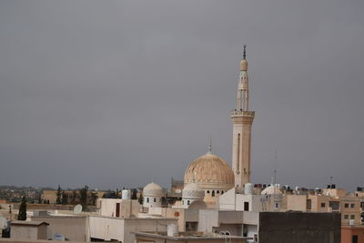 Buildings in city against sky