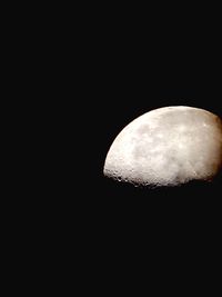 Low angle view of moon in the dark