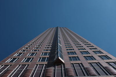 Low angle view of building against clear blue sky