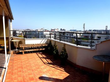 View of swimming pool by balcony against clear sky