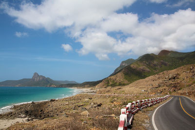 Road by sea against sky