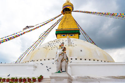 Low angle view of statue against temple building