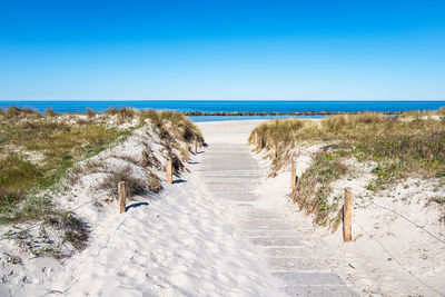 Scenic view of sea against clear blue sky