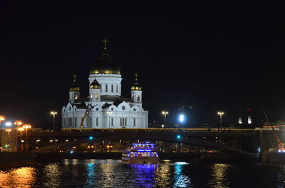 Illuminated building against sky at night