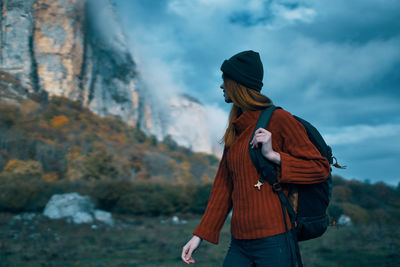 Midsection of man standing on mountain against sky