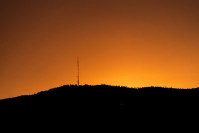 Scenic view of silhouette trees against orange sky