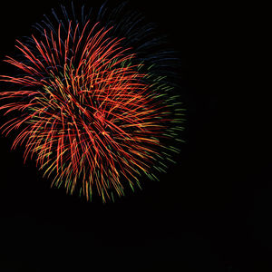 Low angle view of firework display against sky at night