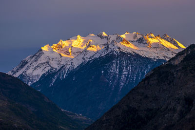 Scenic view of snowcapped mountains against clear sky