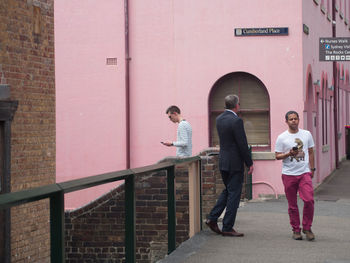 Full length of people walking on building