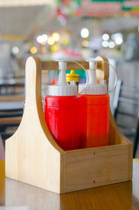 Close-up of red wine bottles on table in restaurant