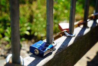 Close-up of padlocks on railing