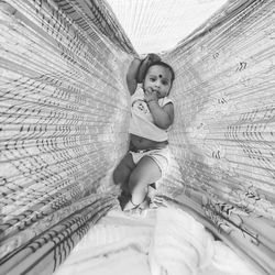 Portrait of baby boy on indian village bed