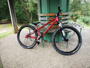 Bicycle parked by tree