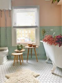 Modern pink and green bathroom with a victorian style bathroom suite.