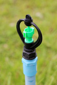 Close-up of coin-operated binoculars on field