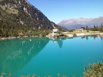 Scenic view of lake and mountains against clear sky