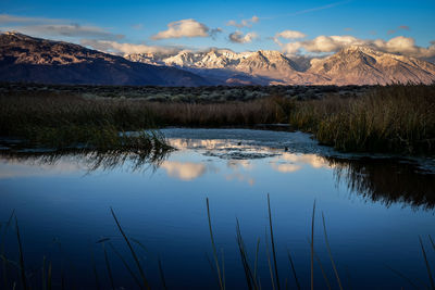 Blue hour in the valley as first light illuminates the mountains reflection in water 