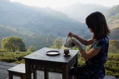 Woman drinking tea in garden