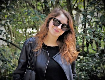 Portrait of smiling young woman wearing sunglasses