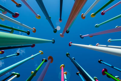High angle view of multi colored pencils against blue sky