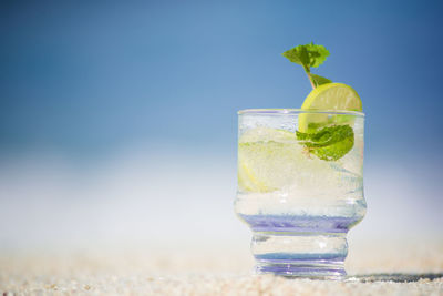 Close-up of drink on beach 